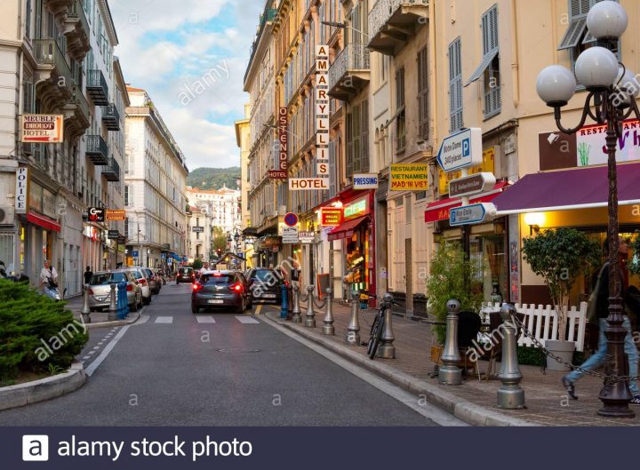 French Citizens And Tourists Walk Through A Colorful Area Of encequiconcerne Hotel Meublé Nice